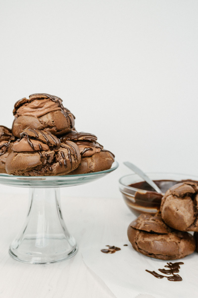 taste before beauty chocolate creme puff with best easy chocolate mousse on a platter and some on the table with chocolate in the background