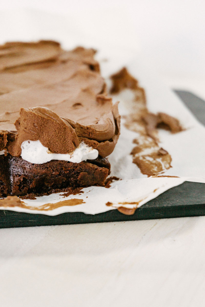 taste before beauty chocolate frosted marshmallow brownie end piece on a cutting board