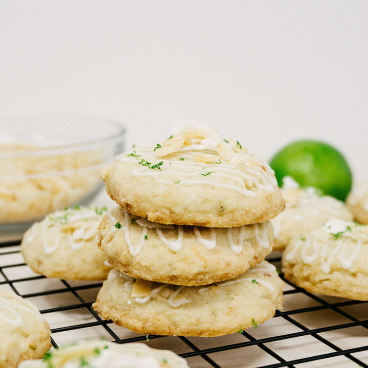 taste before beauty coconut lime shortbread stacked on top of eachother on a grid wire cooling rack