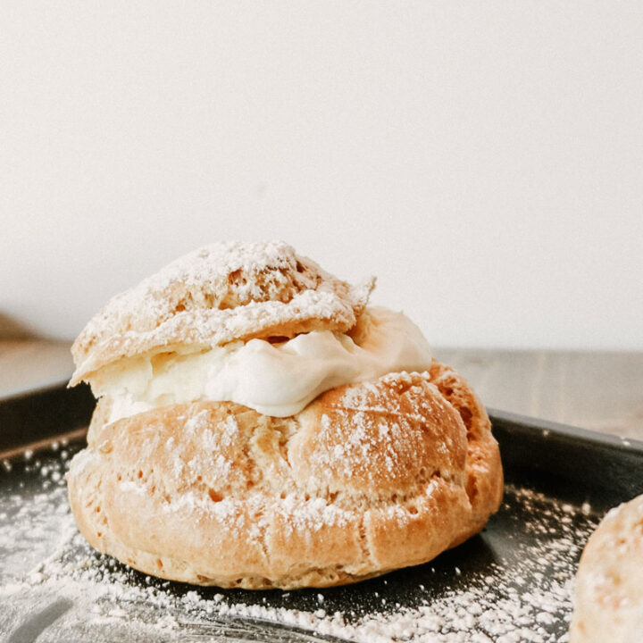 taste before beauty cream puff with powdered sugar on top on a pan