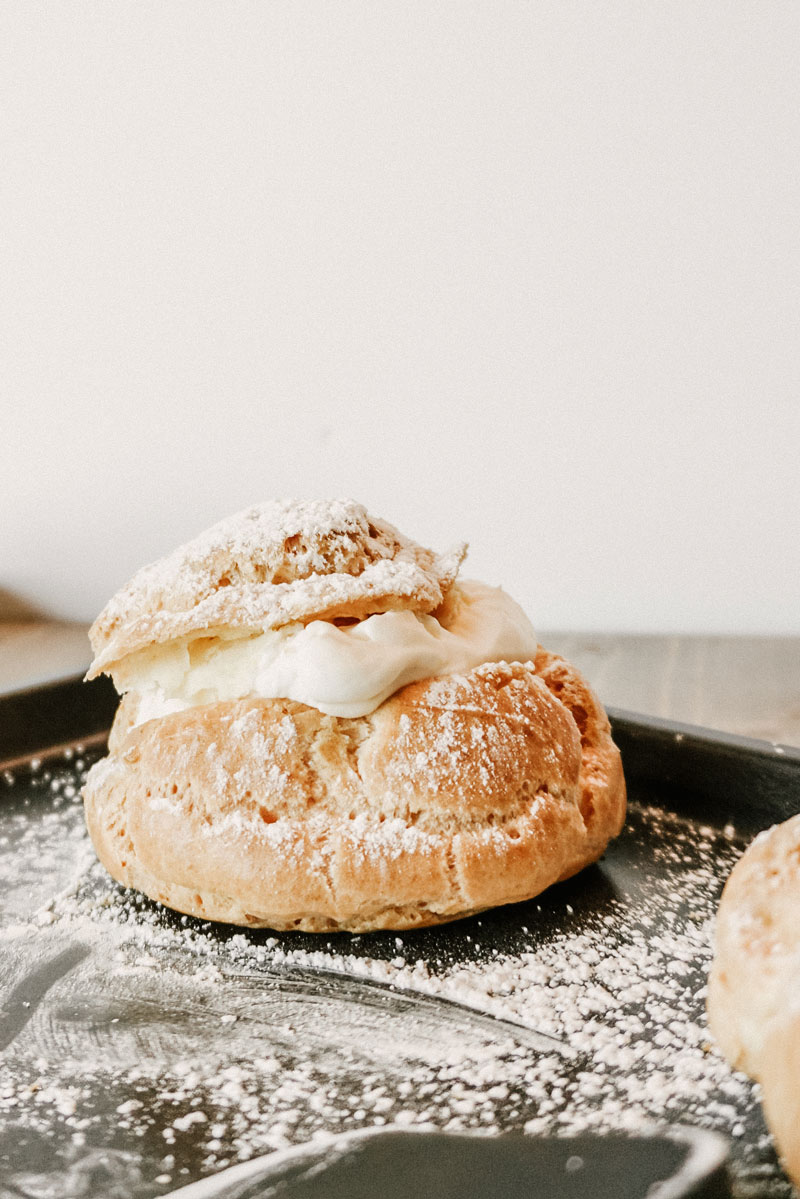 taste before beauty cream puff with powdered sugar on top on a pan