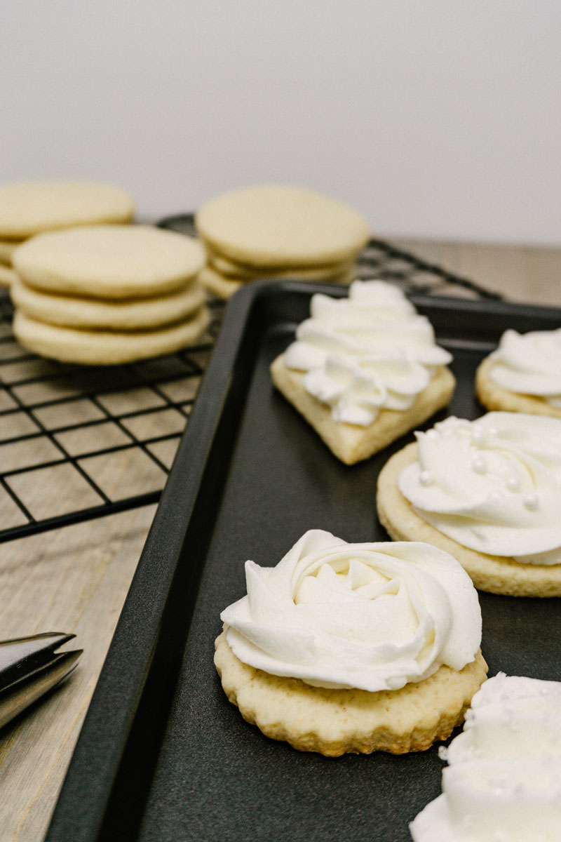 taste before beauty frosted sugar cookies on a pan