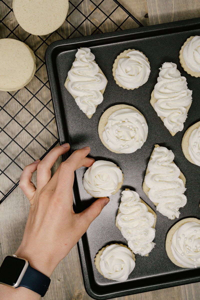 taste before beauty frosted sugar cookies being picked up on a pan