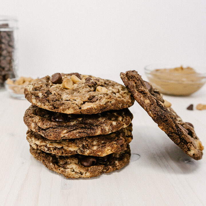 taste before beauty pennsylvania tango peanut butter chocolate chip cookies stacked on top of each other with chocolate chips and peanut butter chips in the background