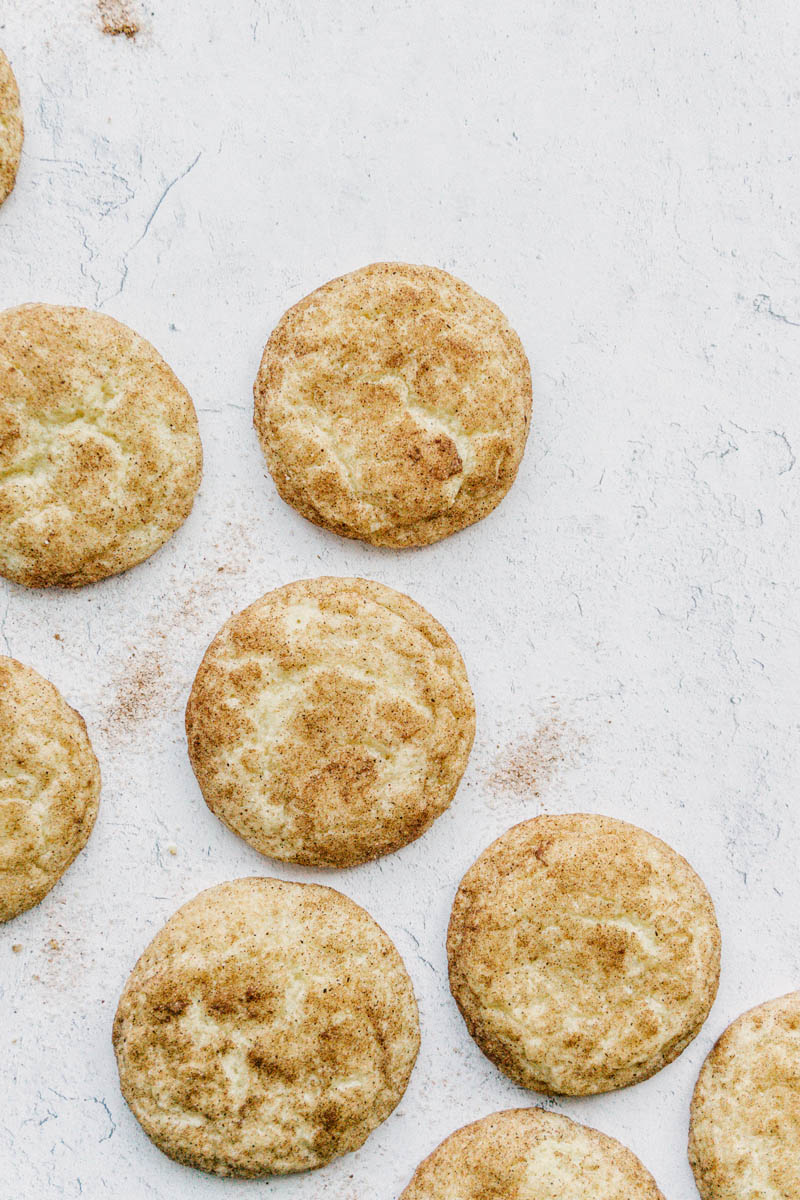 taste before beauty the best snickerdoodle cookies layed out with cinnamon sugar