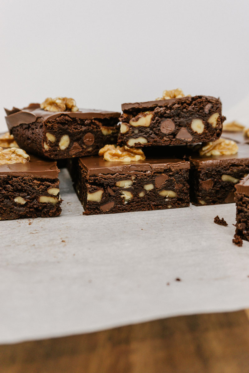 taste before beauty fudge walnut brownies stacked on top of each other