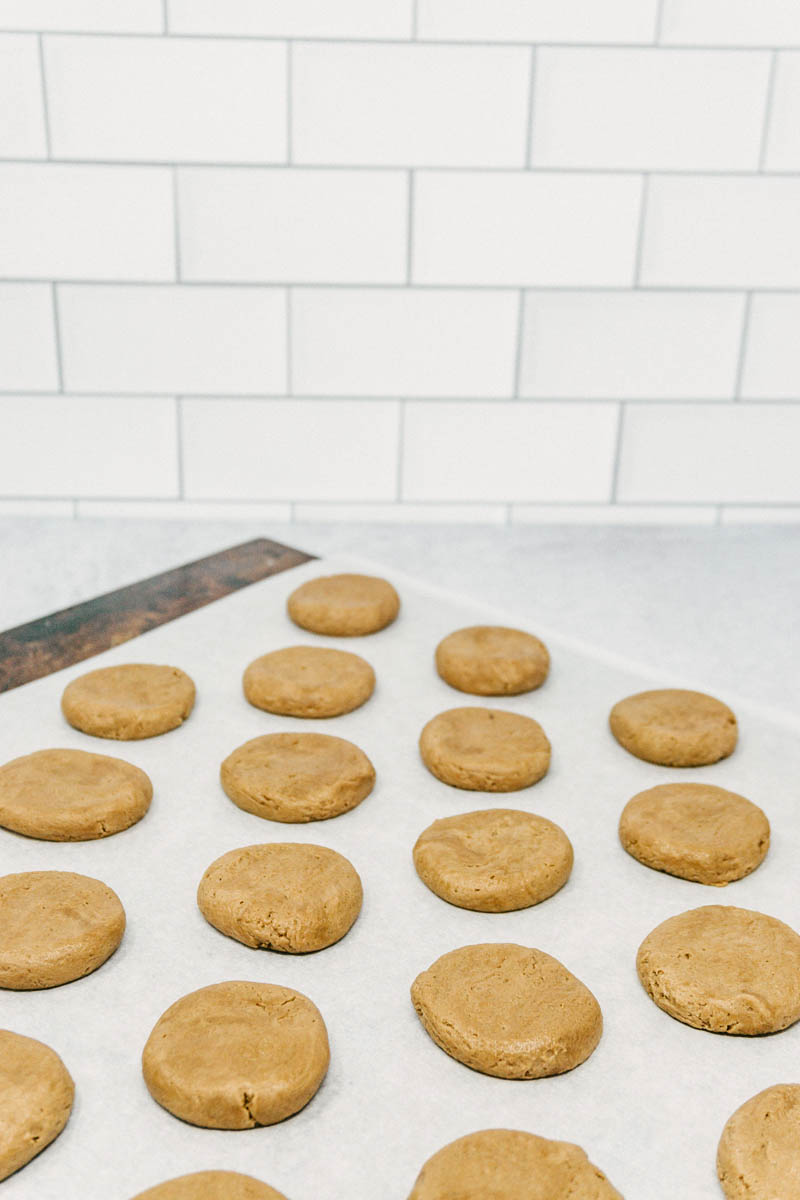 taste before beauty black and white chocolate shortbread cookies on table with white and chocolate drizzles before the are baked