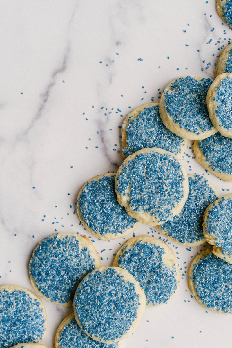 taste before beauty buttery sugar cookies layed out on marble slab with sprinkles