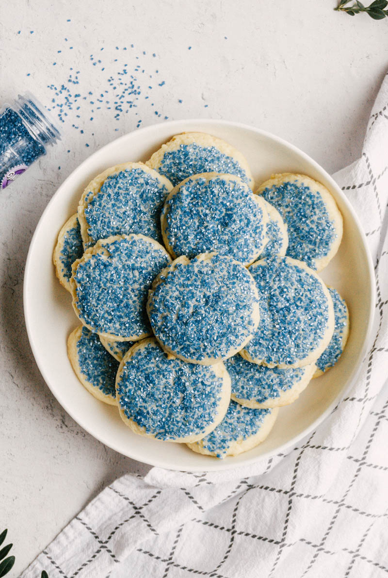 taste before beauty buttery sugar cookies on a plate with blue sprinkles