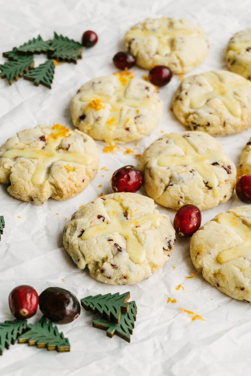 taste before beauty cranberry orange shortbread cookies with wood trees and cranberries layed around