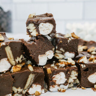 taste before beauty chocolate rocky road fudge pieces cut and stacked on top of each other with marshmallows and nuts inside