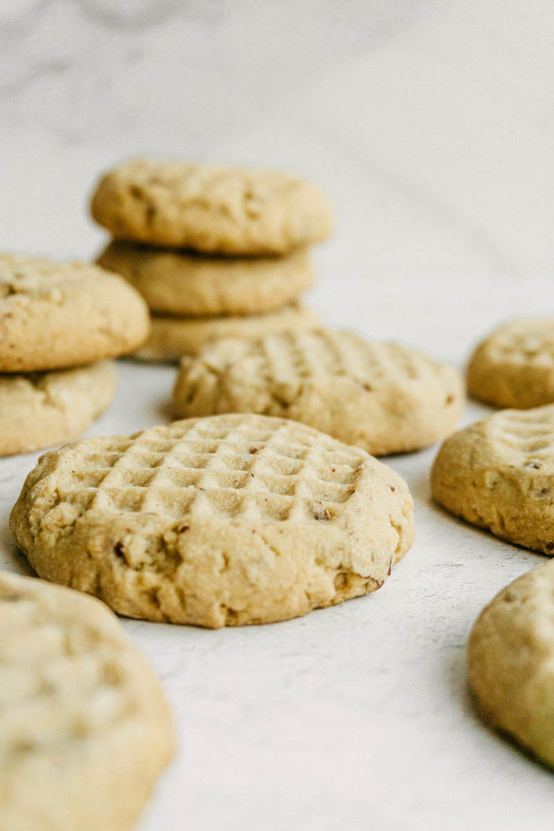 taste before beauty pecan shortbread cookies on table with stacked in back