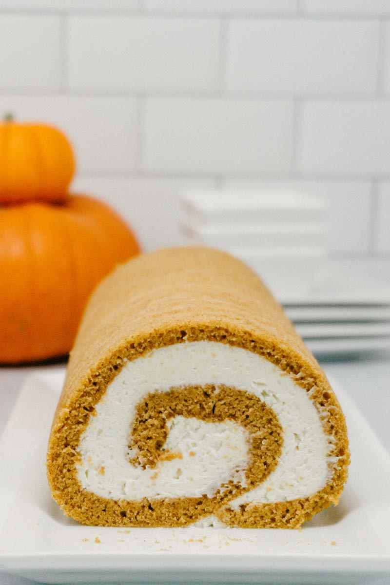 taste before beauty pumpkin roll with cream cheese frosting with pumpkins stacked