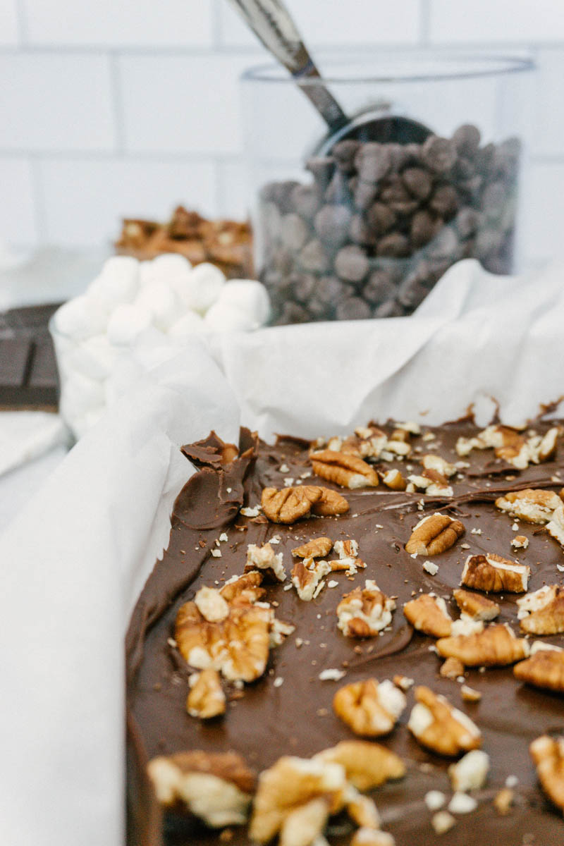 taste before beauty chocolate rocky road fudge in the pan with ingredients and nuts