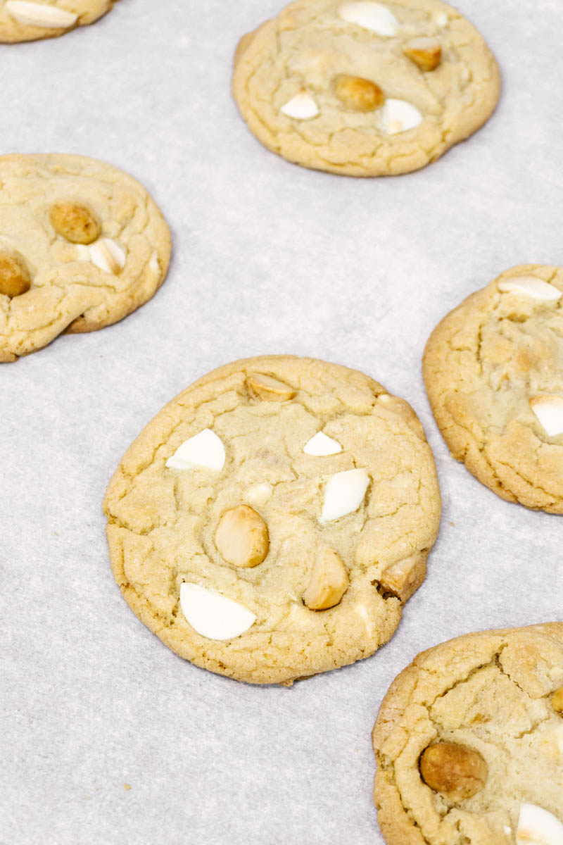 white chocolate macadamia nut cookies layed on parchment paper