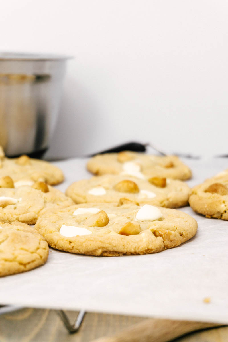 white chocolate macadamia nut cookies on table on parchment paper
