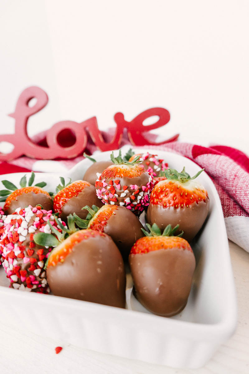 taste before beauty chocolate dipped strawberries in heart dish with sprinkles