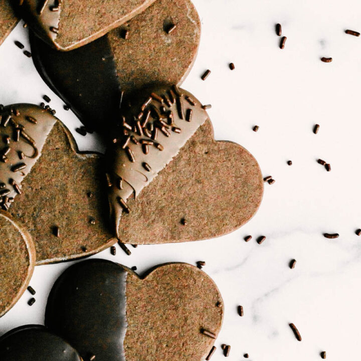 taste before beauty easy crisp chocolate dipped shortbread layed on table with sprinkles