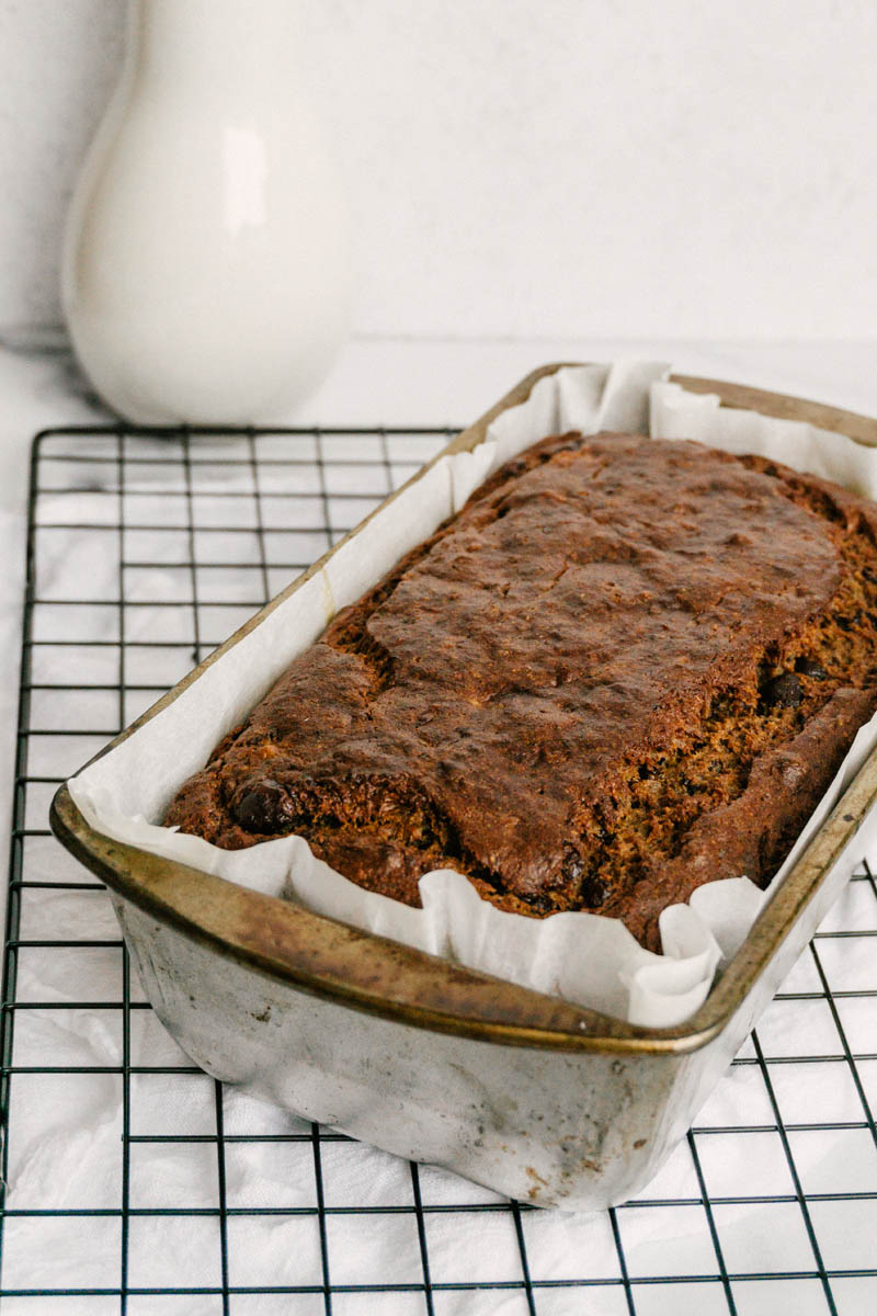 taste before beauty healthy chocolate chip banana bread in pan on cooling wire
