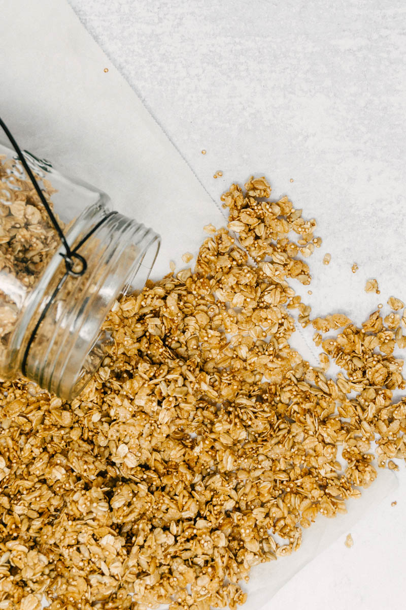 taste before beauty quinoa granola spread out on table from jar