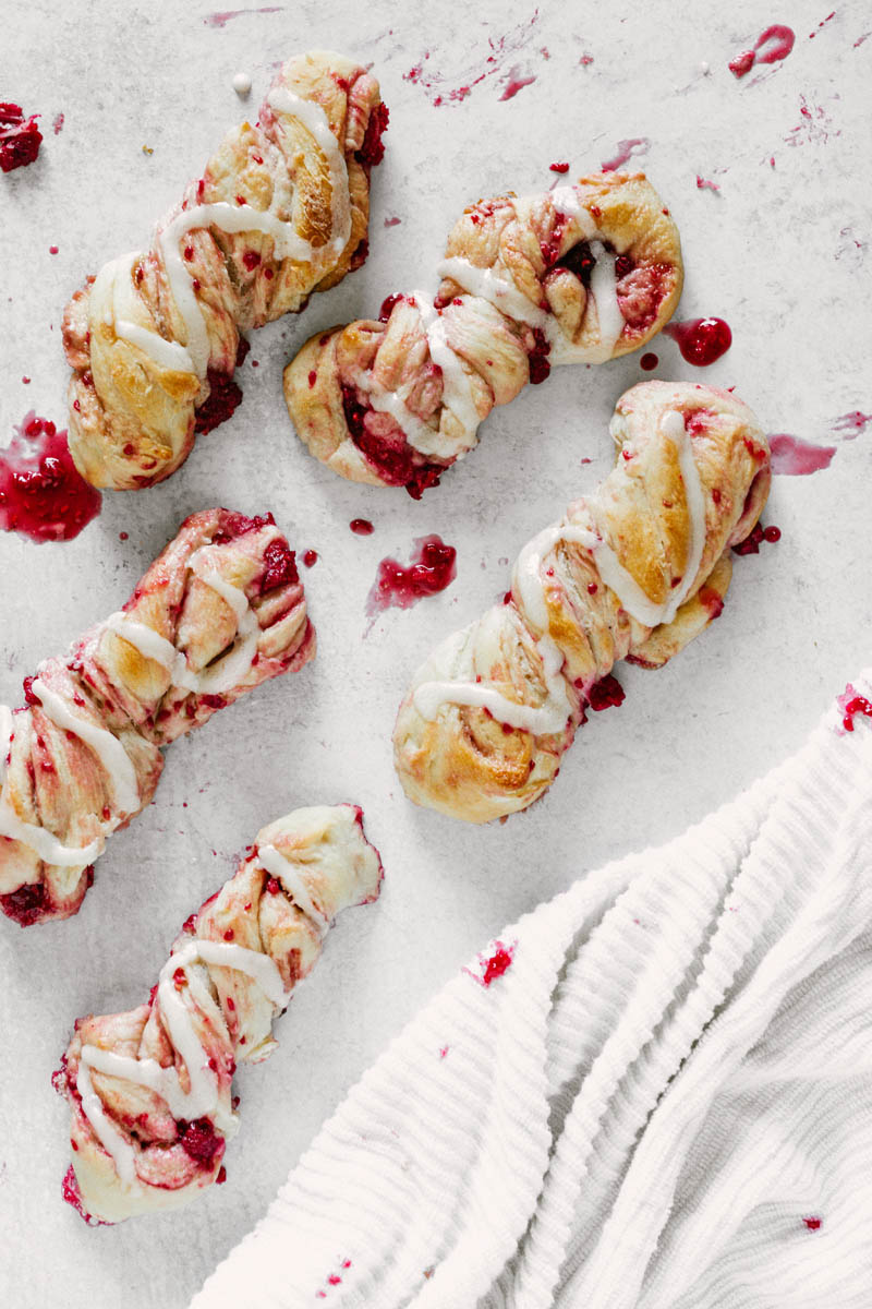 taste before beauty sweet raspberry twists with icing and raspberry on table