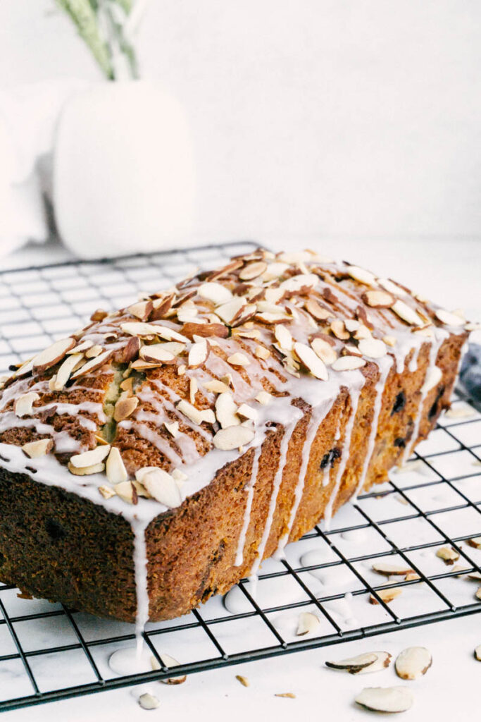 taste before beauty blueberry almond bread on cooling wire with plants and glaze