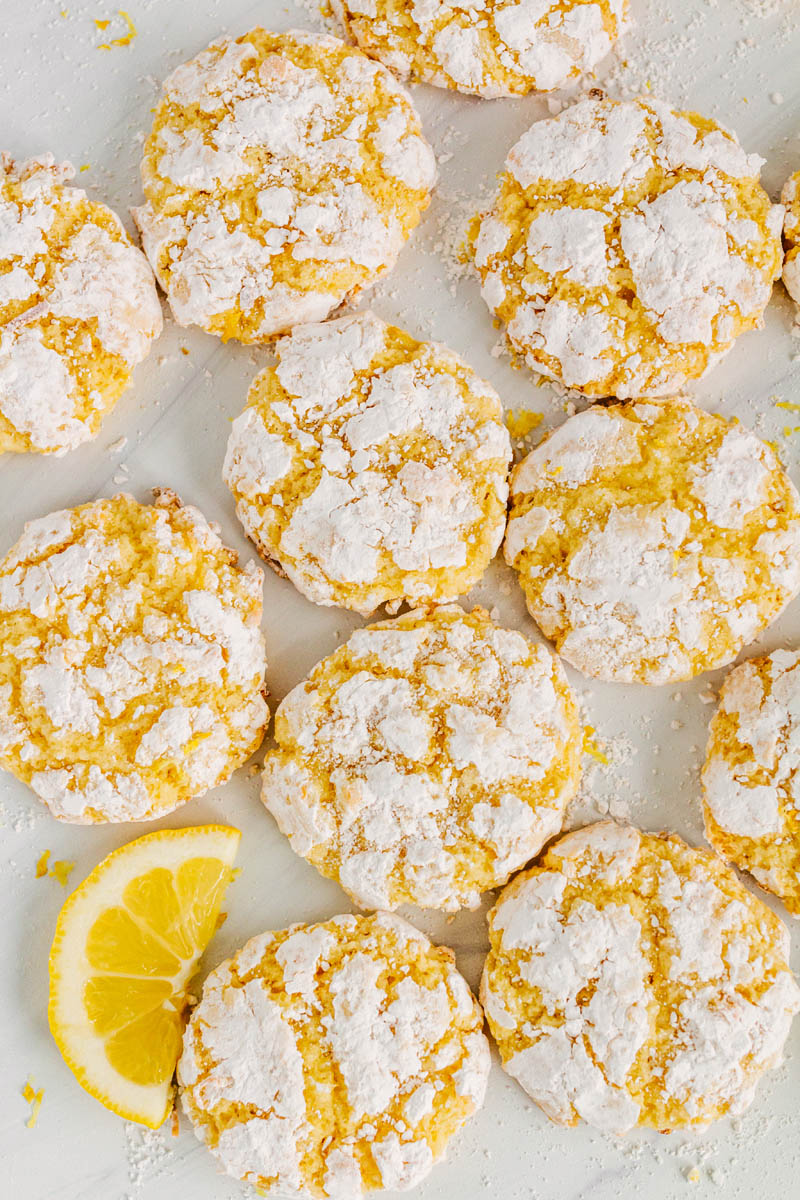 taste before beauty coconut lemon crackle cookies on table with a lemon