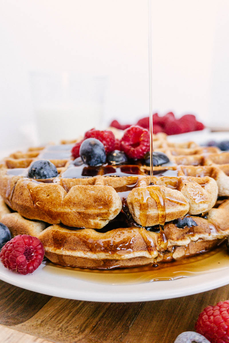 taste before beauty whole wheat waffles on plate with blueberries raspberries milk with syrup drizzle