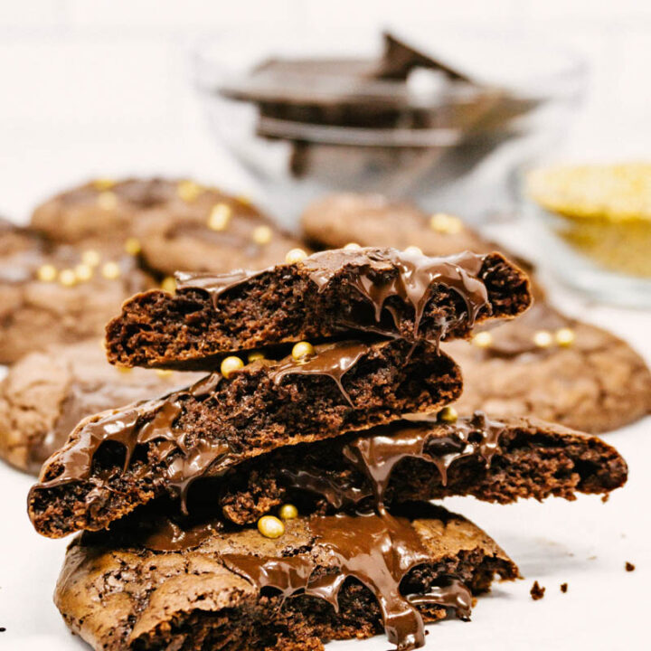 aztec wonder chocolate cayenne cookies stacked on each other with gooey chocolate