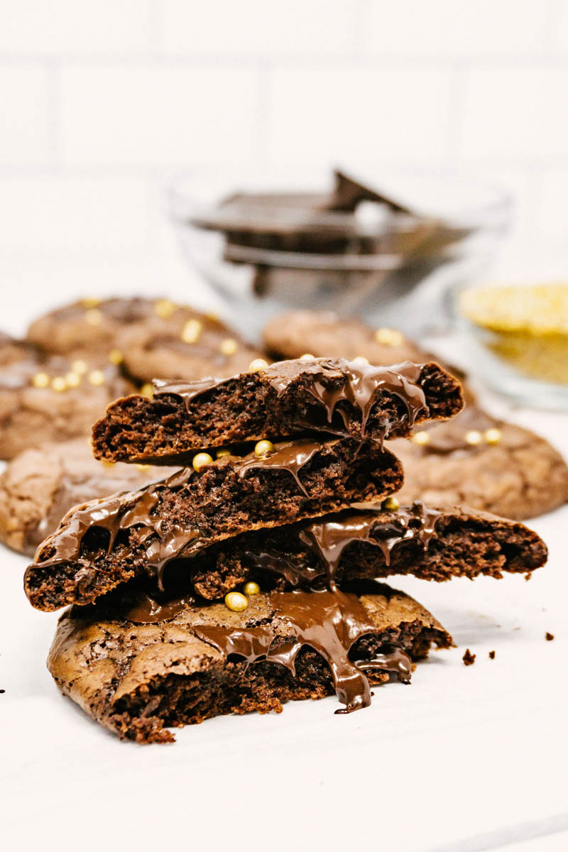 aztec wonder chocolate cayenne cookies stacked on each other with gooey chocolate