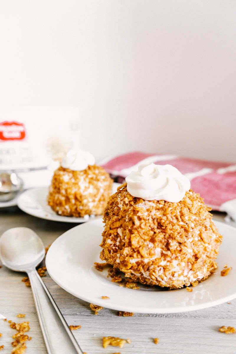 easy fried ice cream balls with cinnamon crunchy coating with cream on top