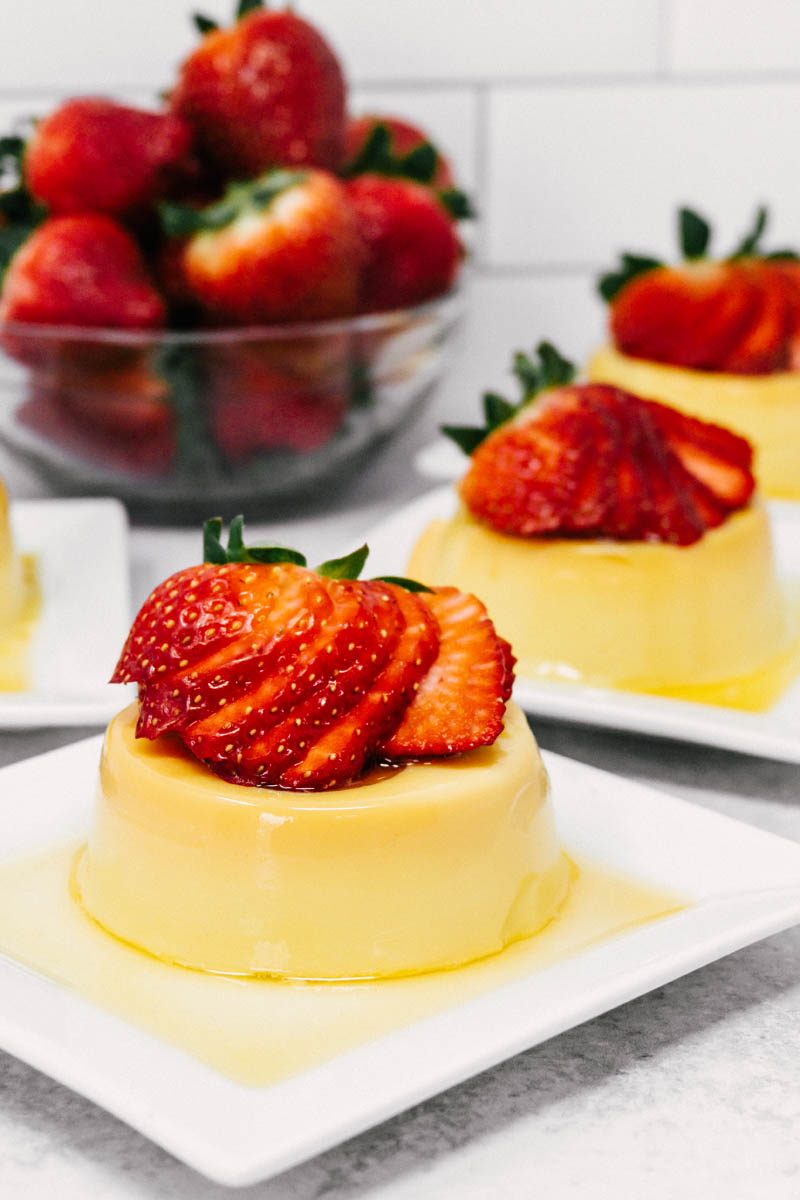 creamy flan on plate with strawberries