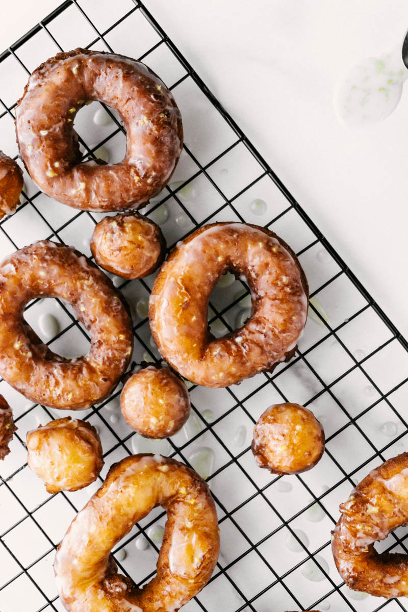 lemon greek yogurt cake donuts spread on wire rack on table