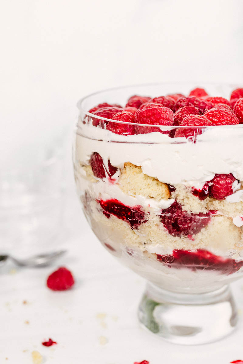 raspberry trifle in a glass dish with raspberries
