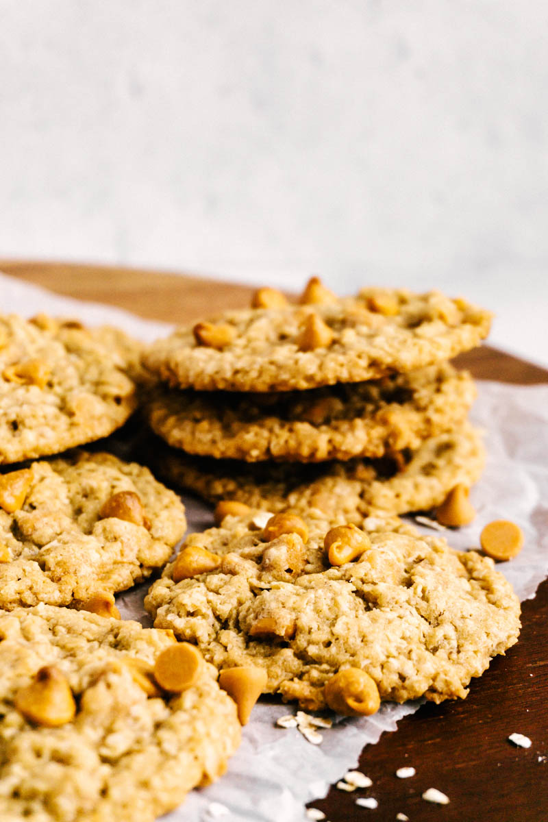 butterscotch oatmeal cookies stacked on wood platter
