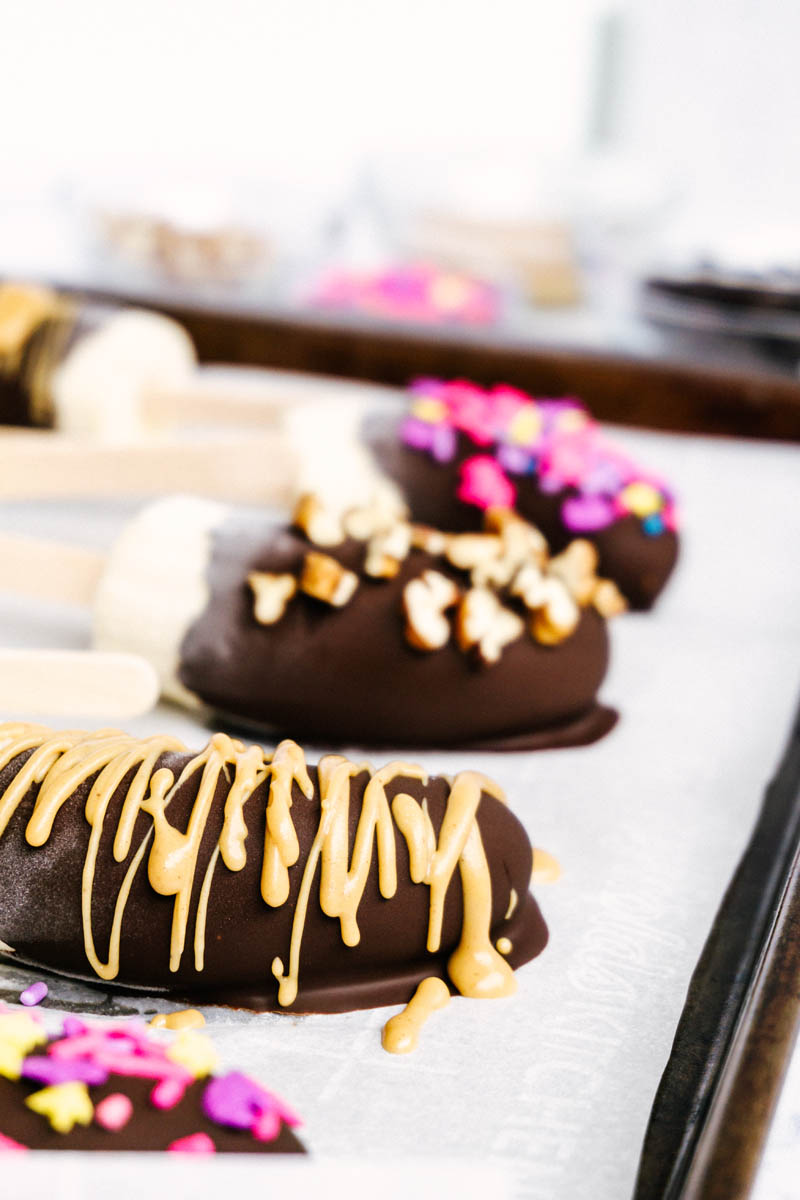 frozen chocolate covered bananas with peanut butter drizzle