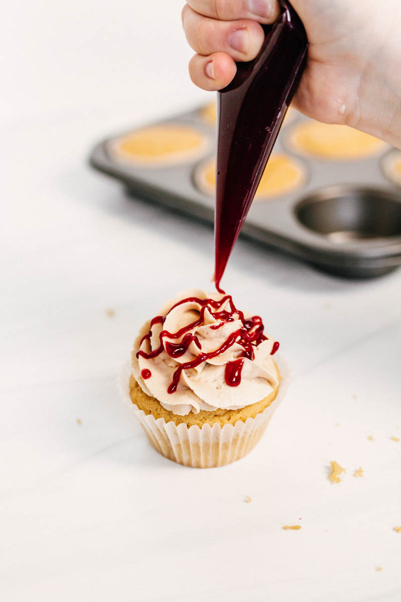 peanut butter and jelly cupcakes with raspberry jam drizzle