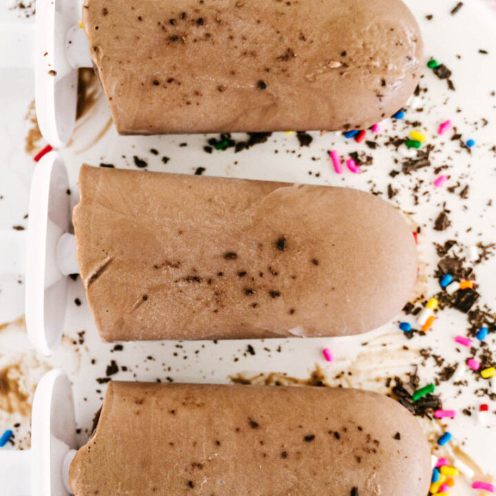 fudgesicles on table with sprinkles and chocolate