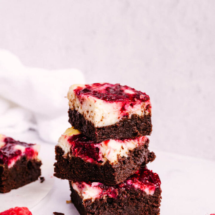 raspberry cheesecake brownies stacked on each other