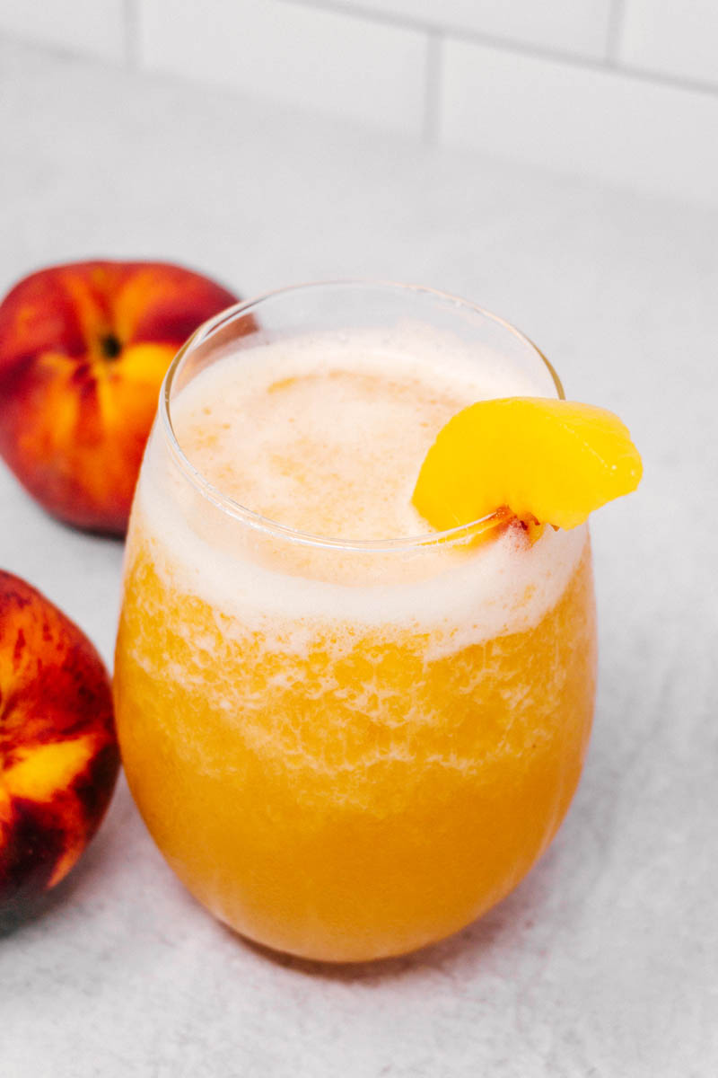 refreshing peach slush punch with peaches on the side