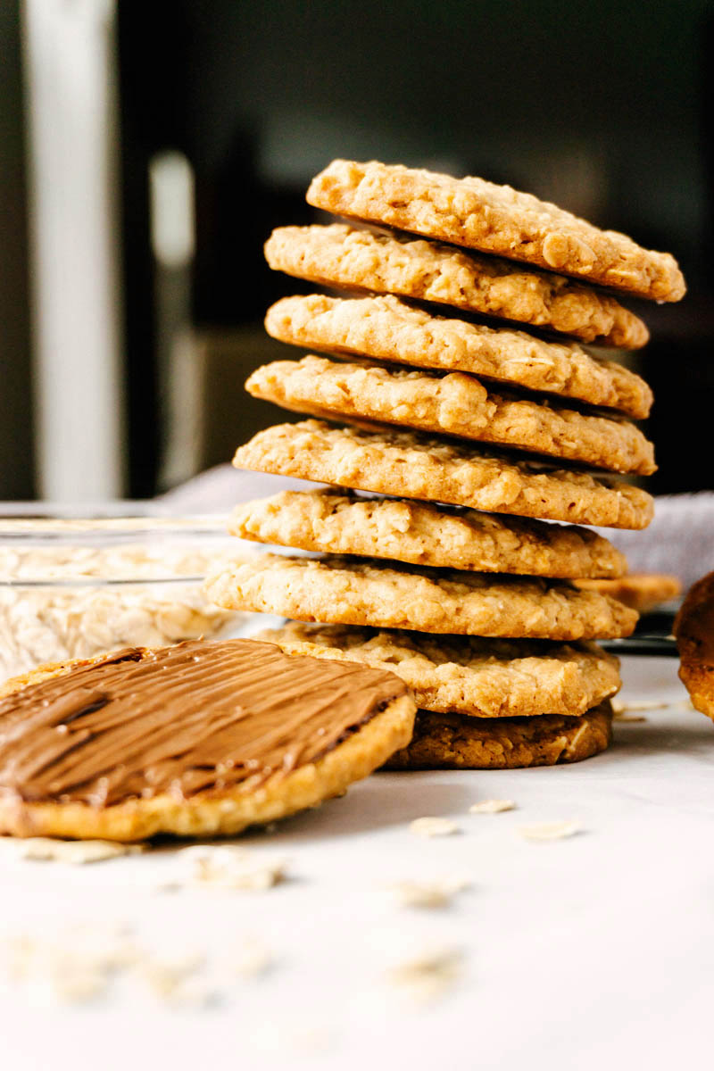 copycat hobnobs oatmeal crumble cookies stacked standing up with chocolate