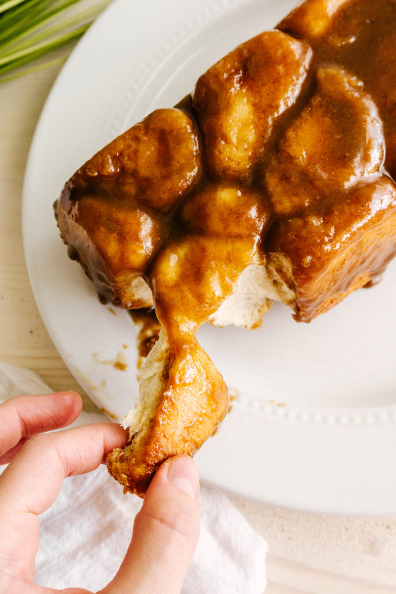 fingers pulling a piece of the easy monkey bread
