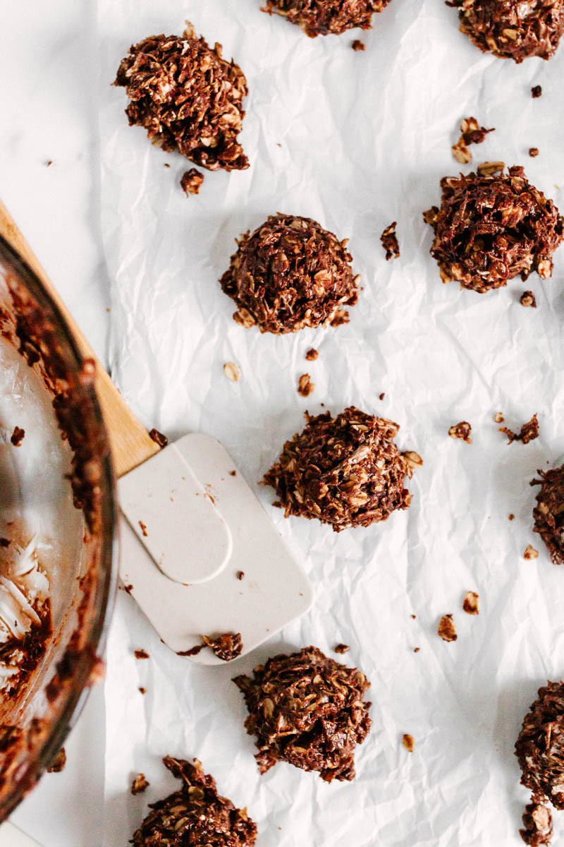 chocolate no bake cookies on parchment paper with glass bowl
