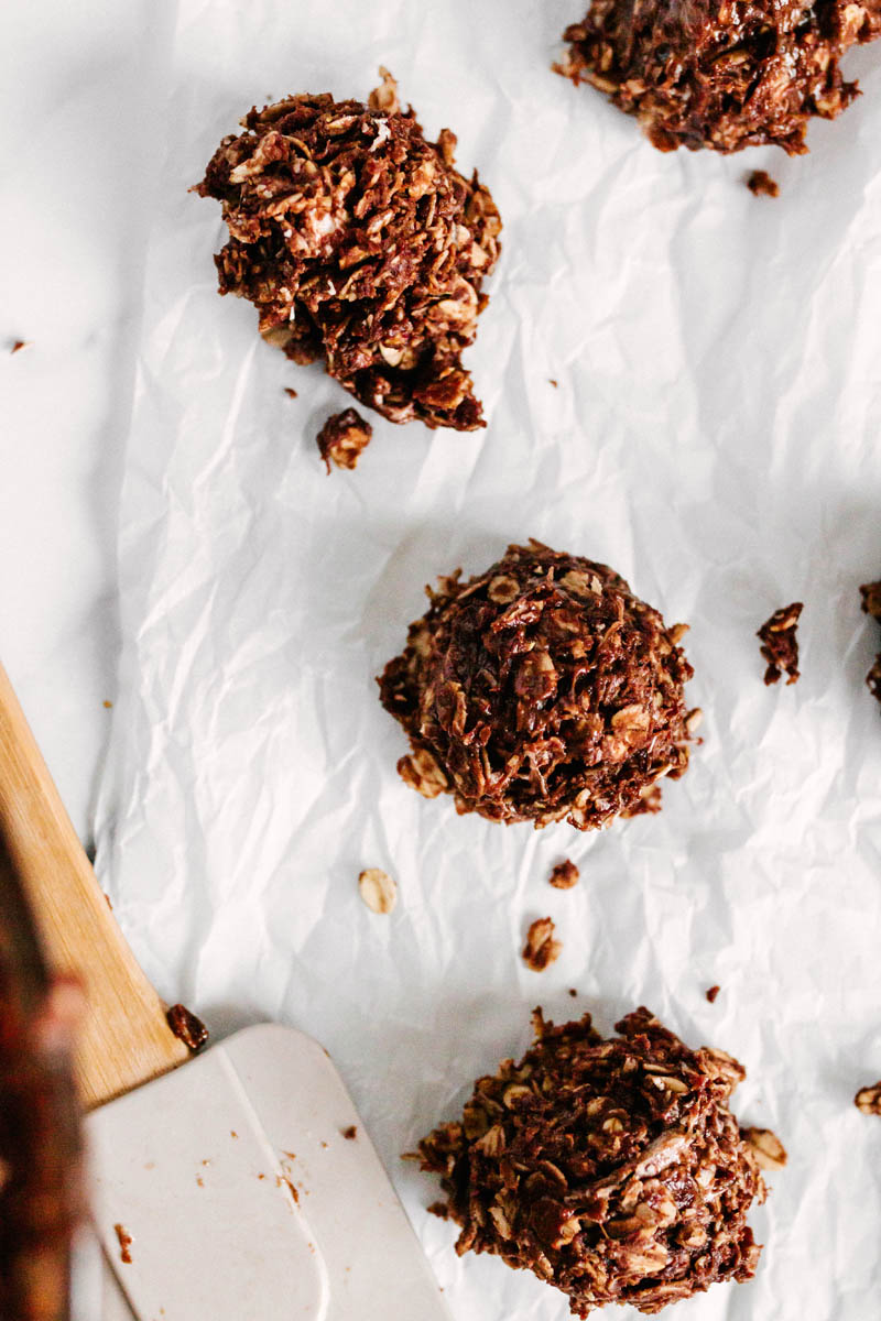 chocolate no bake cookies on parchment paper with spatula