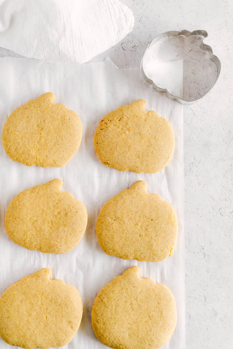 flatlay of unfrosted pumpkin sugar cookies