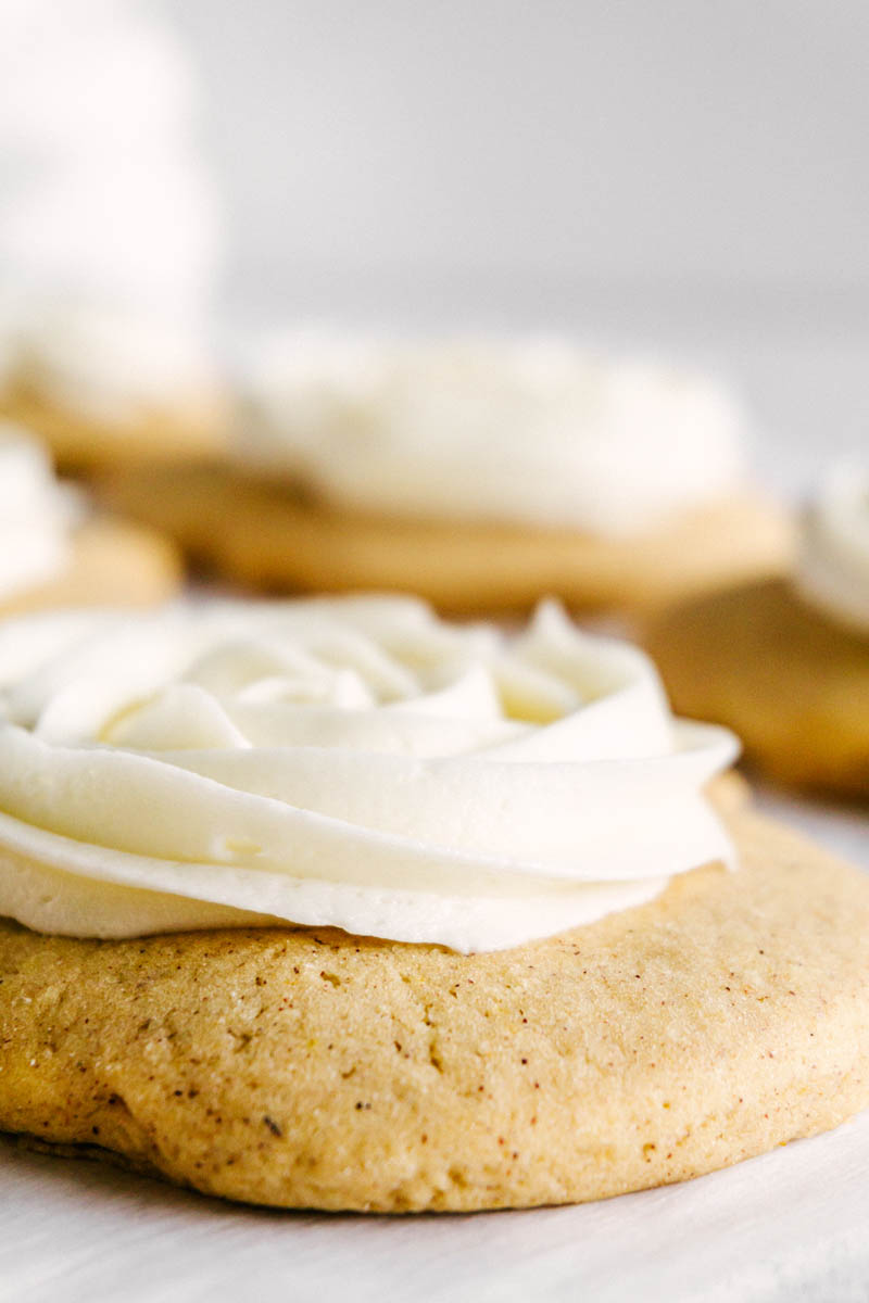 texture upclose of frosted pumpkin sugar cookie