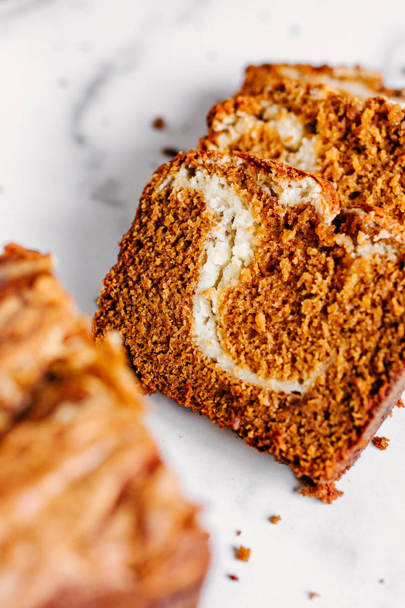 cut slices of the pumpkin bread showing the cream cheese swirl