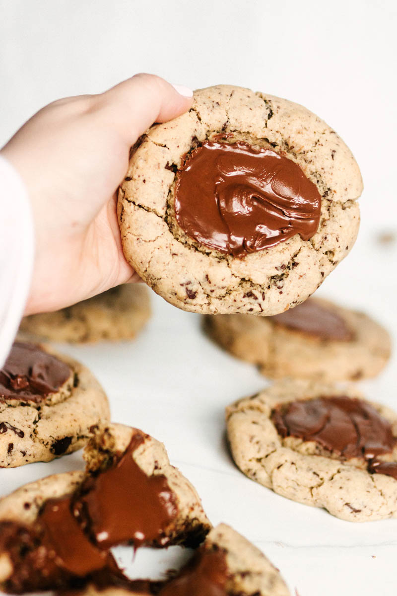 holding up a nutella chocolate chip cookie