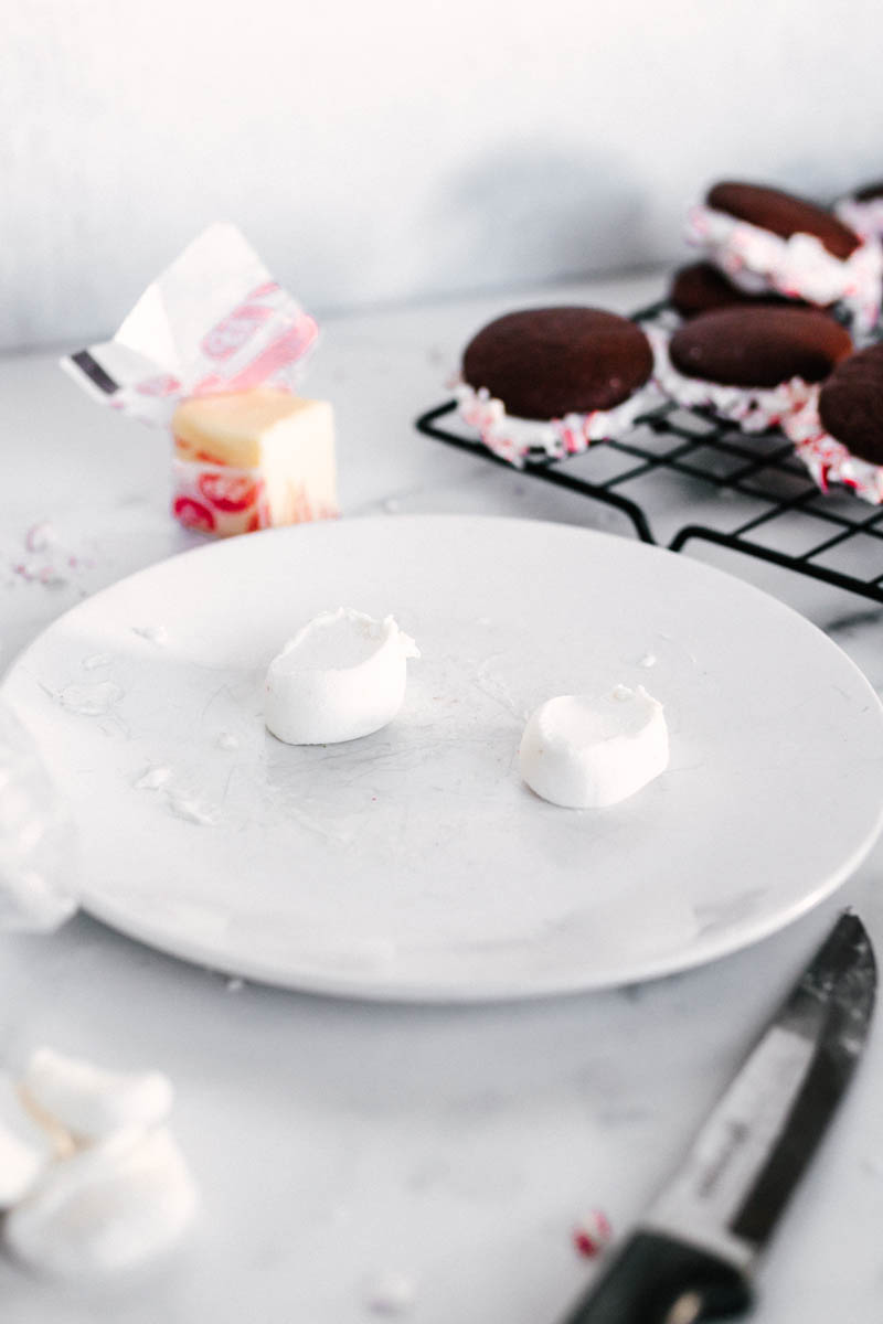chocolate peppermint cookies in the back with marshmallows on a plate