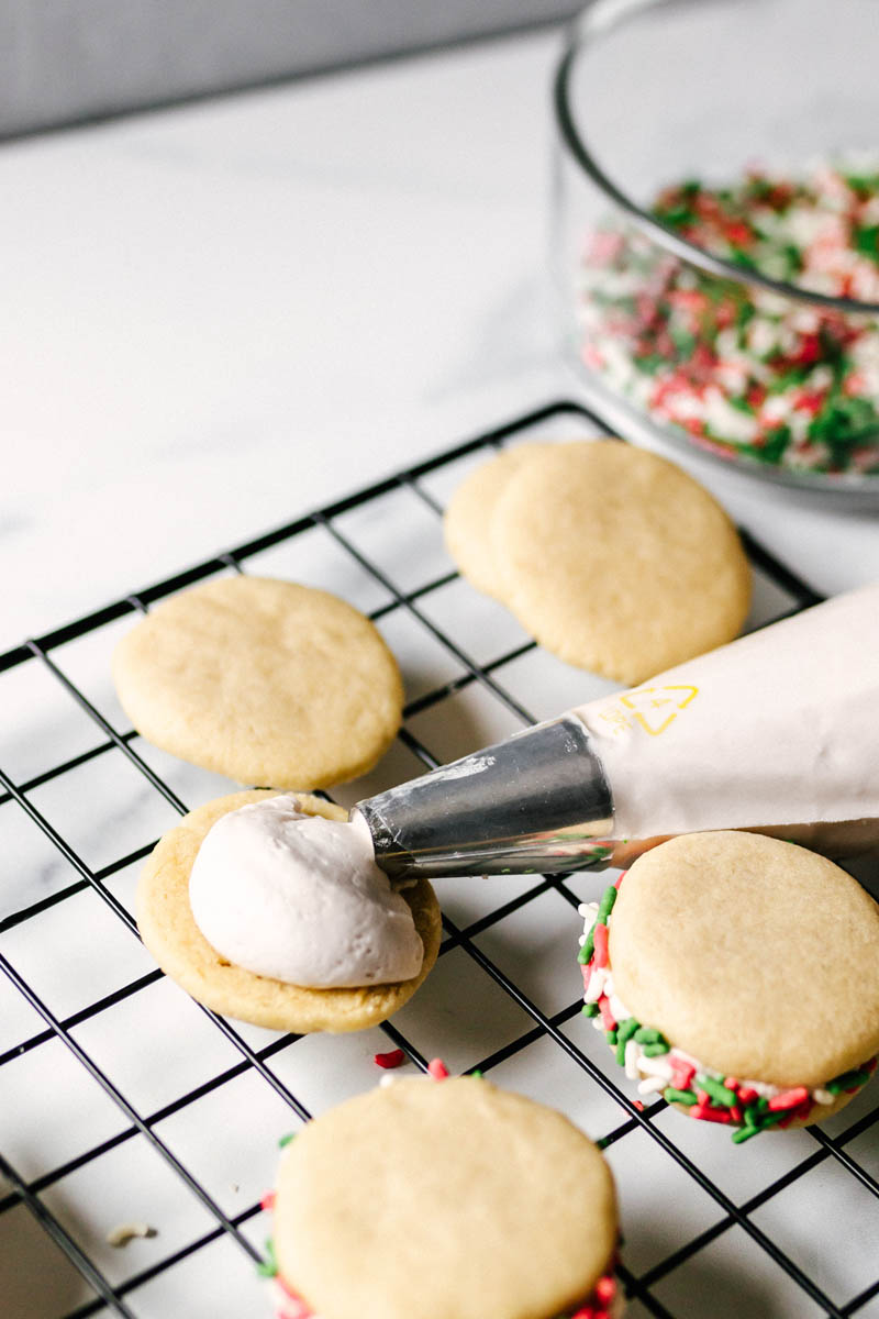 piping frosting onto a cookie